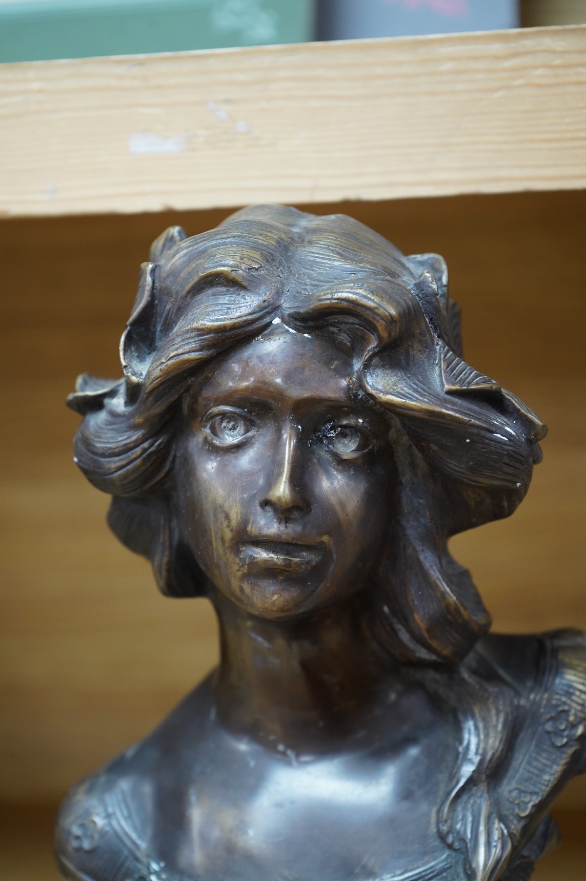 A French Art Nouveau bronze bust of a maiden, unsigned, 32cm high